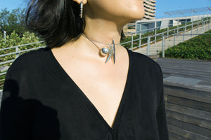 Model wearing sterling silver necklace with three pendants styled like a choker.