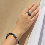 Model wearing sterling silver dome ring and bracelet with ridged design.
