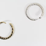 Top view of sterling silver and gold brass bracelets.