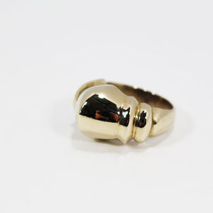 Front view of sculptural gold brass ring.