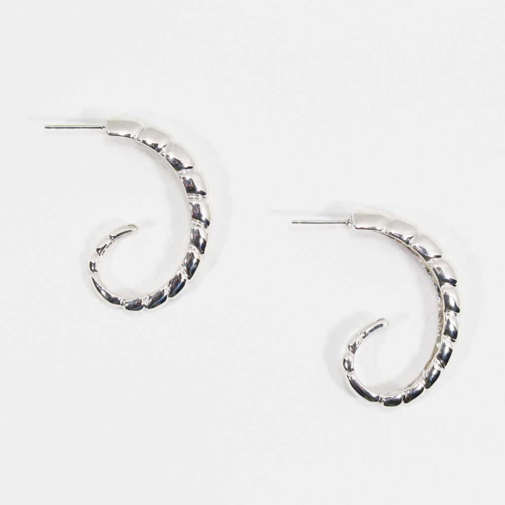 Pair of sterling silver hoop earrings with ridged texture.