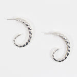 Pair of sterling silver hoop earrings with ridged texture.