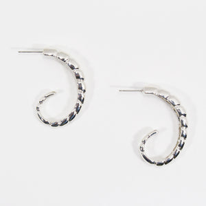 Pair of sterling silver hoop earrings with ridged texture.
