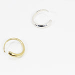 One gold and one silver rings with tapered, organic design.