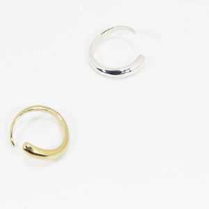 One gold and one silver rings with tapered, organic design.